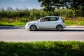 Fast moving Kia Ceed EW on the country road. Compact white hatchback with a man driving. First generation of popular Korean Royalty Free Stock Photo