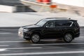 Fast moving Lexus LX 500d on the city road. Black SUV with man driving. Premium auto in fast motion with blurred background. Royalty Free Stock Photo