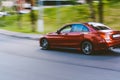 Fast moving red car with motion blur effect. overspeed concept Royalty Free Stock Photo