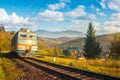 Fast moving train in autumn mountains Royalty Free Stock Photo