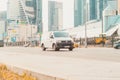 Fast moving van Volkswagen Transporter T6 on the city road. White minivan rides on street Royalty Free Stock Photo