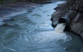 Water flowing through culvert pipe into natural river stream Royalty Free Stock Photo