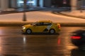 Fast moving yandex taxi car with motion blur effect. overspeed concept. Motion city street scene with yellow taxi vehicle at night Royalty Free Stock Photo