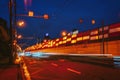 Fast night driving traffic of city, tunnel entrance. Abstract blurred background of urban moving cars. Transportation Royalty Free Stock Photo