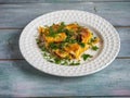 Fast nutritious breakfast with omelet, tomatoes and fresh herbs on a white plate Royalty Free Stock Photo