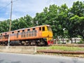 Fast orange train on rail in bangkok. heavy diesel engine transportation industrial cargo vehicle