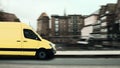 Fast parcel delivery, yellow mail van in a historic small town