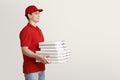 Fast pizza delivery. Courier holds many boxes of pizza