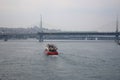 Fast red boat floating to Golden Horn Metro Bridge