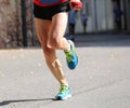 Fast runner runs on a paved street of the city