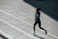 Fast runner. Young african american woman in sportive clothes have workout outdoors at daytime