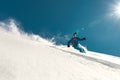 Fast skier rides over ski slope