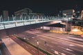 Fast traffic and pedestrian overpass in the modern city by night Royalty Free Stock Photo