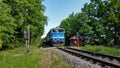 Fast train with blue engine near Trebon station