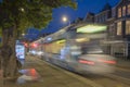 Fast tram running through The Hague, Den Haag in Dutch, city skyline at late evening
