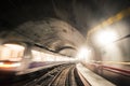 Fast underground train riding in a tunnel of the modern city Royalty Free Stock Photo