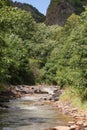 Fast water flow close-up. Nature background with cascades of a mountain stream in close-up. Idyllic landscape with clear water Royalty Free Stock Photo