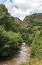 Fast water flow close-up. Nature background with cascades of a mountain stream in close-up. Idyllic landscape with clear water Royalty Free Stock Photo