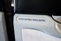 Fasten seat belt sign information on airplane Royalty Free Stock Photo