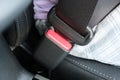 Fastened buckle and a red button of a safety belt, seatbelt in car, traffic regulations concept