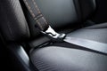 a fastened seatbelt against a grey car seat Royalty Free Stock Photo