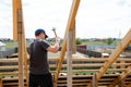 Fasteners and installation of roof rafters by workers. Preparation for laying slate. Construction and installation