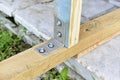Fasteners of a wooden structure with the help of an iron corner and self-tapping screws Royalty Free Stock Photo
