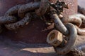 Fastening the chain with a large bolt. At the end of the chain is an old rusty bolt. Securing the ship with a large chain. Old