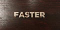 Faster - grungy wooden headline on Maple - 3D rendered royalty free stock image