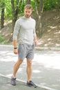 Fastest way to get in shape. Sportsman walk on sidewalk. Strong sportsman wear fitness uniform. Sportsman training