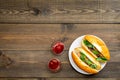 Fastfood concept. Make fresh hotdogs and home. bun for hot dogs with freid sausages and basil near tomato sause on dark Royalty Free Stock Photo