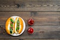 Fastfood concept. Make fresh hotdogs and home. bun for hot dogs with freid sausages and basil near tomato sause on dark Royalty Free Stock Photo