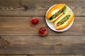 Fastfood concept. Make fresh hotdogs and home. bun for hot dogs with freid sausages and basil near tomato sause on dark Royalty Free Stock Photo