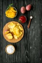 Cooking homemade potato chips with ketchup on wooden background top view Royalty Free Stock Photo