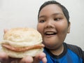 Fat Asian boy enjoys fast food Royalty Free Stock Photo