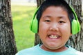 Chubby Asian boy wears music headphones