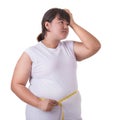 Fat Asian woman wear white t-shirt and checking her body size wi Royalty Free Stock Photo