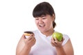 Fat asian woman wearing white t-shirt and choosing to eat green Royalty Free Stock Photo