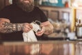Fat bearded tapster laboring in pub Royalty Free Stock Photo