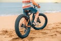Fat bike on the beach with guy riding on it Royalty Free Stock Photo
