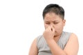 Fat boy covering his nose because of a bad foul smell