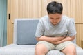 Fat boy feeling stomachache and sitting on the sofa, Diarrhea concept Royalty Free Stock Photo