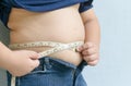 Fat boy measuring his belly Royalty Free Stock Photo