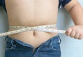 Fat boy measuring his belly Royalty Free Stock Photo