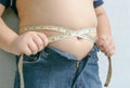 Fat boy measuring his belly Royalty Free Stock Photo