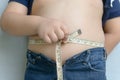 Fat boy measuring his belly Royalty Free Stock Photo