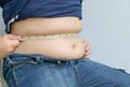 Fat boy measuring his belly Royalty Free Stock Photo