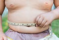 Fat boy measuring his belly. Royalty Free Stock Photo