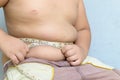 Fat boy measuring his belly with measurement tape Royalty Free Stock Photo