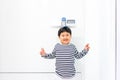 A fat boy is measuring his height himself in hospital Royalty Free Stock Photo